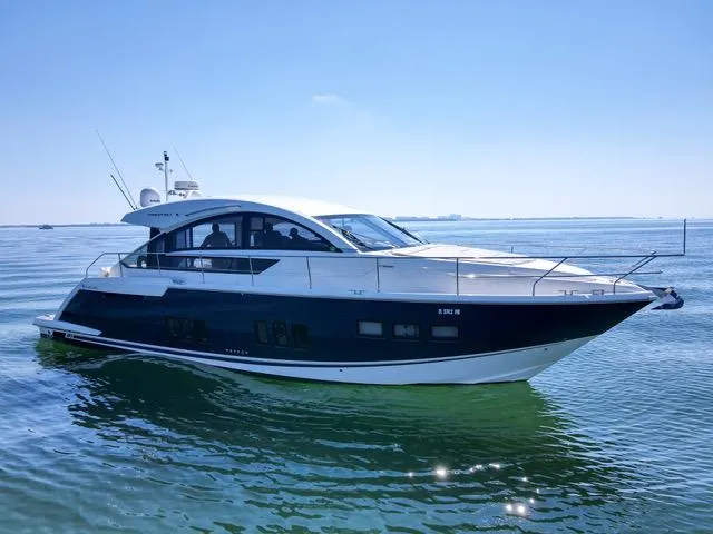 Slide: The Image of 2013 Fairline Targa 50 GT yacht cruising on calm waters under a clear blue sky. - 6
