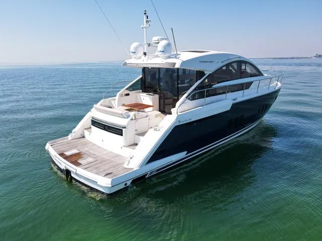 Slide: The Image of 2013 Fairline Targa 50 GT yacht on calm water, showcasing sleek design and spacious deck. - 7