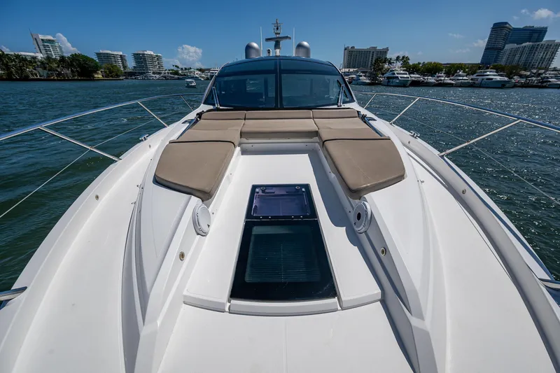 Slide: The Image of 2019 Sunseeker Predator 50 yacht with sunbathing deck, docked in a marina. - 16