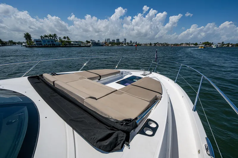 Slide: The Image of 2019 Sunseeker Predator 50 yacht with sun loungers on deck, cruising on a sunny day. - 17