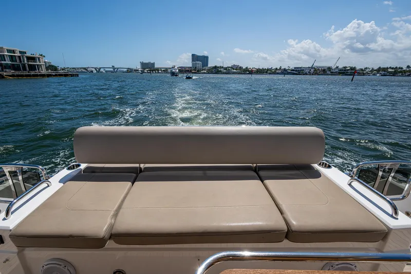 Slide: The Image of 2019 Sunseeker Predator 50 yacht, rear view, cruising on open water under clear skies. - 22