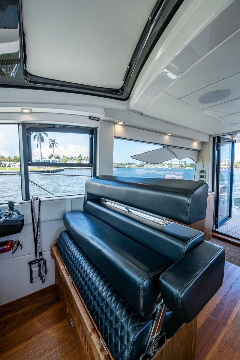 Slide: The Image of Luxurious interior of 2019 Sunseeker Predator 50 yacht with leather seating and scenic water view. - 35