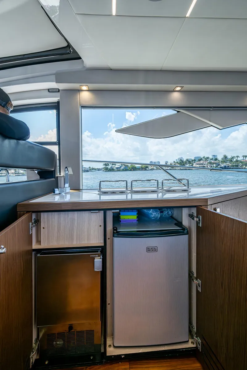 Slide: The Image of Interior view of 2019 Sunseeker Predator 50 yacht with open cabinet and ocean backdrop. - 37
