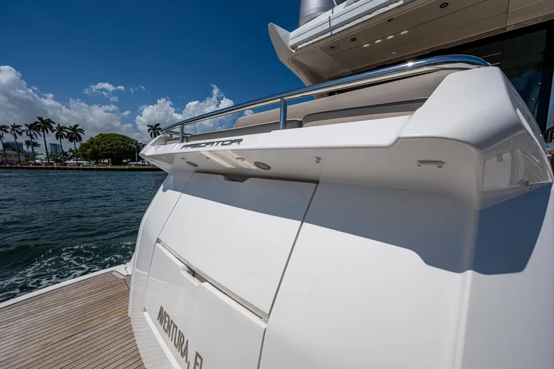 Slide: The Image of 2019 Sunseeker Predator 50 yacht docked by the water, showcasing sleek design and luxury. - 9