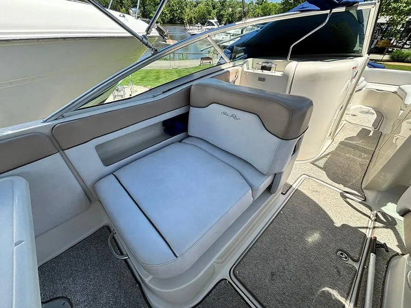 Slide: The Image of 2009 Sea Ray 290 Sundeck boat interior with cushioned seating and carpeted flooring. - 12