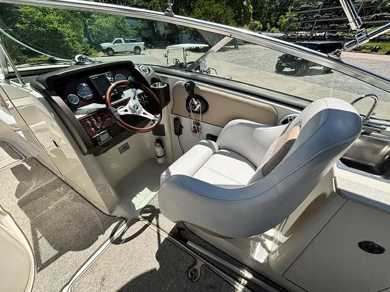 Slide: The Image of 2009 Sea Ray 290 Sundeck cockpit with steering wheel and control panel. - 14