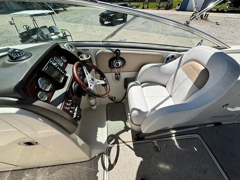 Slide: The Image of 2009 Sea Ray 290 Sundeck cockpit with steering wheel and captain's chair. - 15