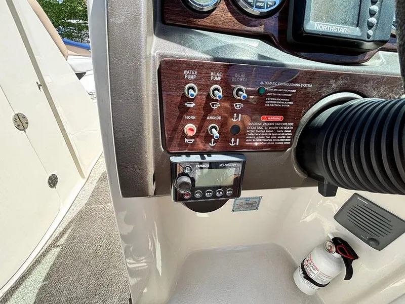 Slide: The Image of Control panel of a 2009 Sea Ray 290 Sundeck boat with various switches and gauges. - 17