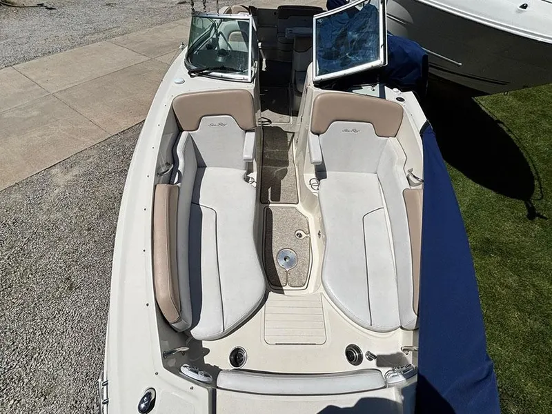 Slide: The Image of 2009 Sea Ray 290 Sundeck boat interior with beige seating and open windshield. - 21