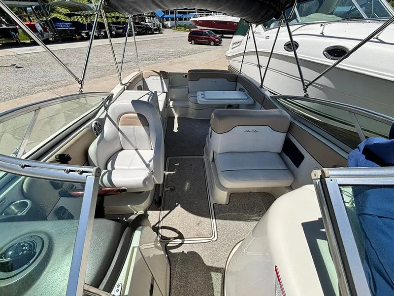 Slide: The Image of 2009 Sea Ray 290 Sundeck boat interior with seating and canopy. - 23
