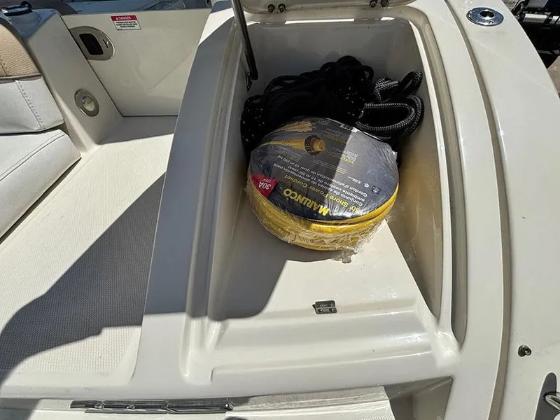 Slide: The Image of 2009 Sea Ray 290 Sundeck storage compartment with coiled rope and accessories. - 6