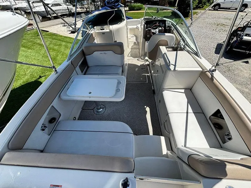 Slide: The Image of 2009 Sea Ray 290 Sundeck boat interior with spacious seating and table setup. - 7