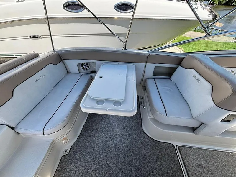 Slide: The Image of 2009 Sea Ray 290 Sundeck interior with seating and table, featuring elegant design and comfort. - 8