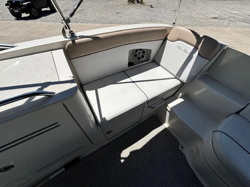 Slide: The Image of 2009 Sea Ray 290 Sundeck interior with cushioned seating and speaker. - 9