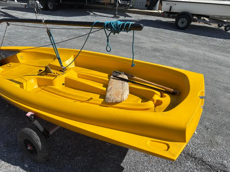 Slide: The Image of Yellow 2002 Captiva Escape sailboat on trailer with wooden oar and rigging. - 7