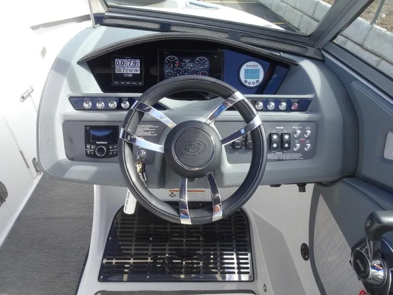 Slide: The Image of 2018 Cobalt R5 Surf boat dashboard with steering wheel and control panel. - 10