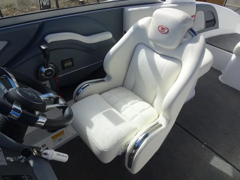 Slide: The Image of 2018 Cobalt R5 Surf boat interior with white captain's chair and steering wheel. - 11