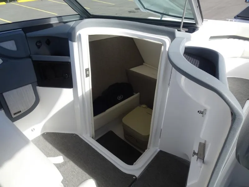 Slide: The Image of 2018 Cobalt R5 Surf boat interior with open cabin door, showing seating and storage. - 13