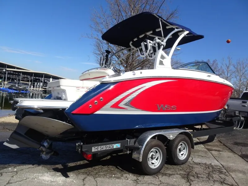 Slide: The Image of 2018 Cobalt R5 Surf boat in red and blue on a trailer. - 2