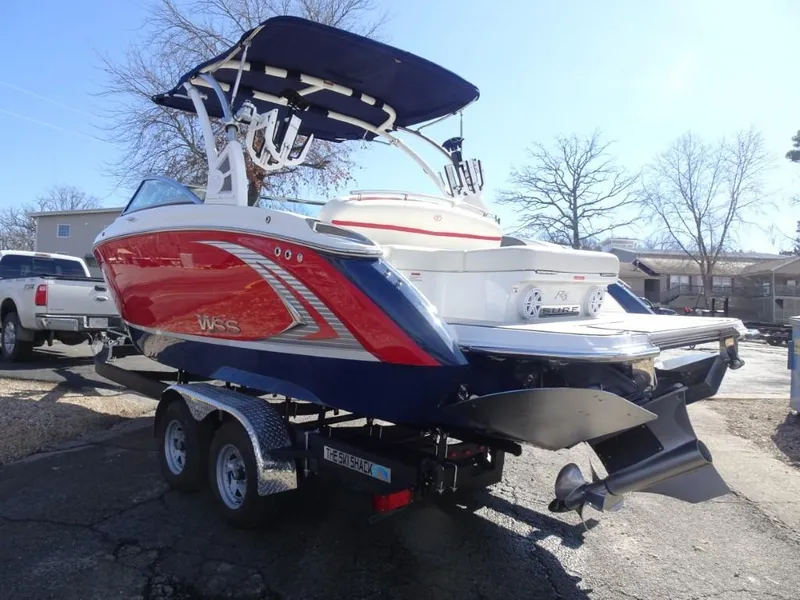 Slide: The Image of 2018 Cobalt R5 Surf boat on trailer, red and blue design, parked outdoors. - 4