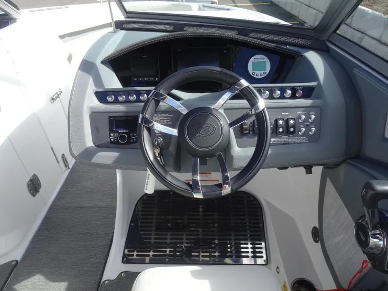 Slide: The Image of 2018 Cobalt R5 Surf boat dashboard with steering wheel and control panel. - 9