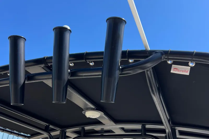 Slide: The Image of Rod holders on a 2022 Boston Whaler 190 Montauk boat with Sunbrella fabric canopy. - 17