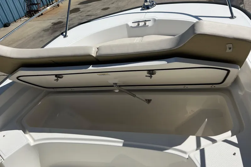 Slide: The Image of 2022 Boston Whaler 190 Montauk boat storage compartment open, showcasing spacious interior. - 6