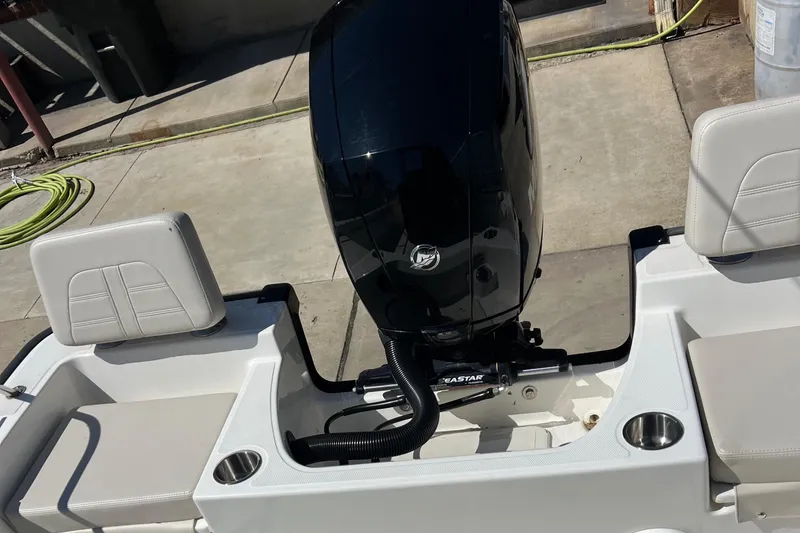 Slide: The Image of 2022 Boston Whaler 190 Montauk boat engine and seating area. - 9