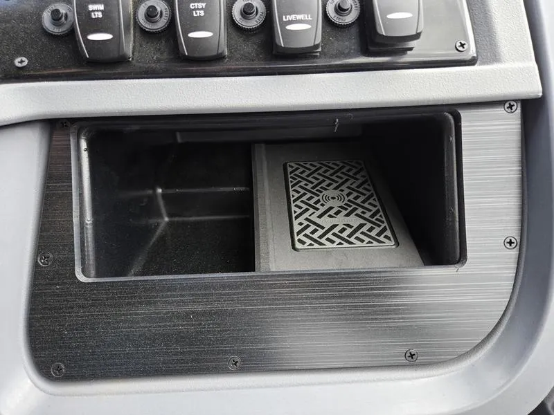 Slide: The Image of Control panel of 2025 Godfrey Sweetwater 2286 SFLC boat with switches and storage compartment. - 12