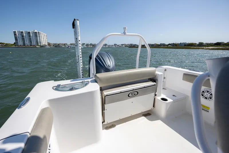 Slide: The Image of 2022 Sportsman Open 232 Center Console boat on water, featuring spacious deck and modern design. - 12