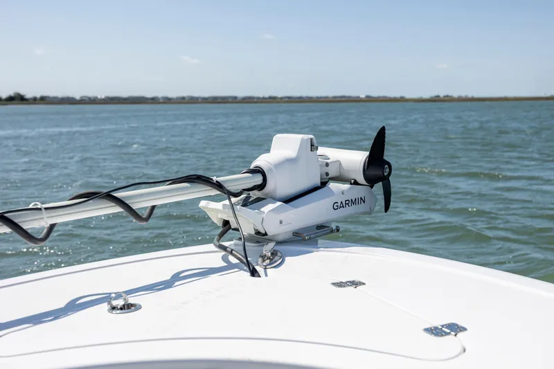 Slide: The Image of 2022 Sportsman Open 232 Center Console with Garmin trolling motor on calm water. - 13