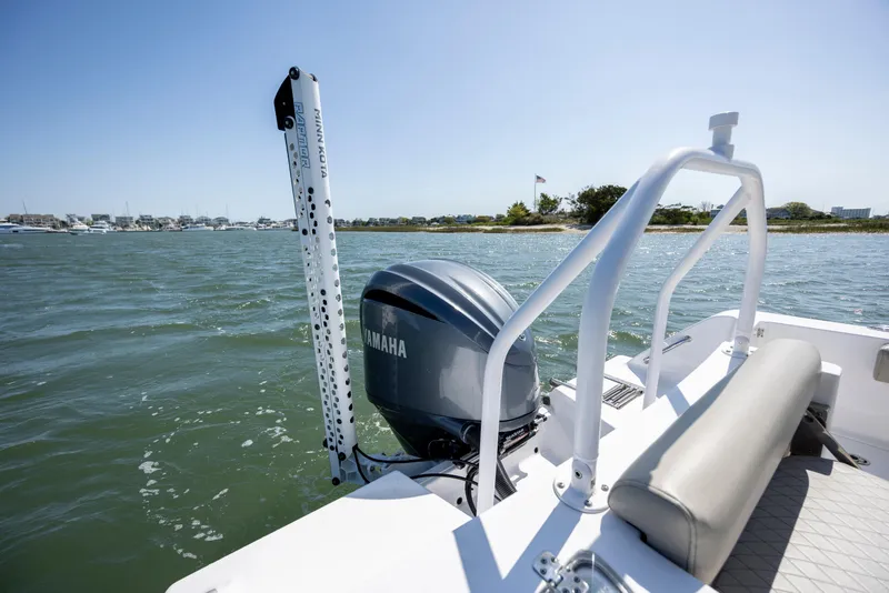 Slide: The Image of 2022 Sportsman Open 232 Center Console boat with Yamaha engine on water. - 14