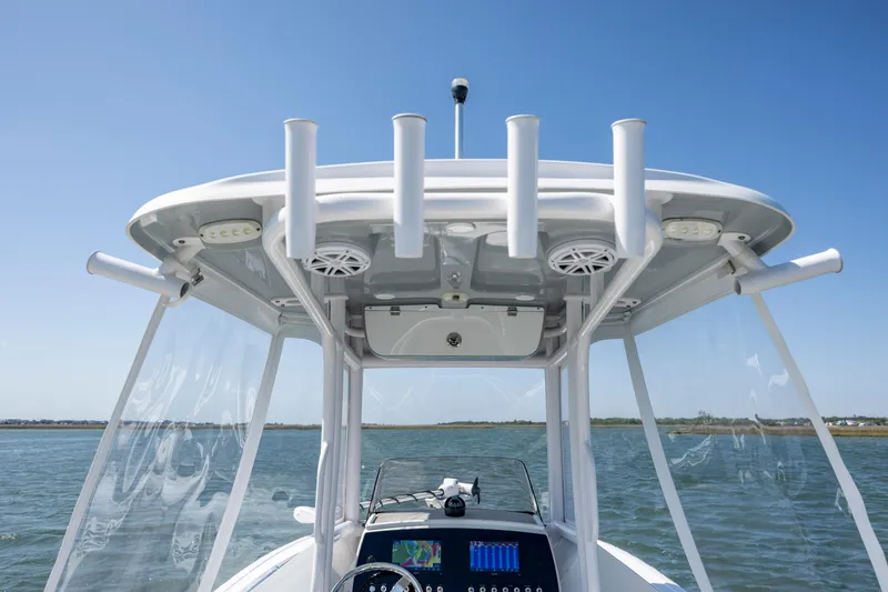 Slide: The Image of 2022 Sportsman Open 232 Center Console boat with rod holders and clear skies. - 15