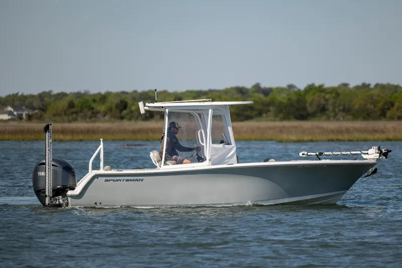 Slide: The Image of 2022 Sportsman Open 232 Center Console boat cruising on calm water. - 2
