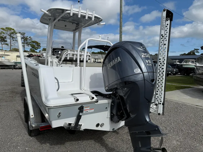 Slide: The Image of 2022 Sportsman Open 232 Center Console boat with Yamaha V6 engine, parked outdoors. - 21