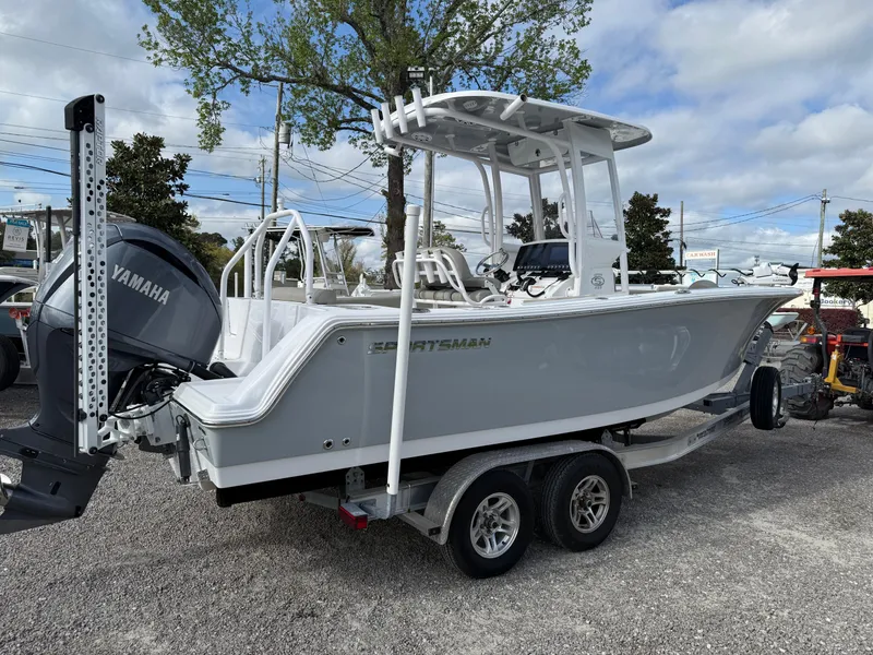 Slide: The Image of 2022 Sportsman Open 232 Center Console boat on trailer with Yamaha engine, parked outdoors. - 24