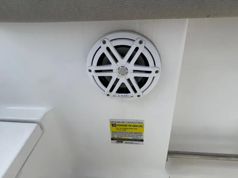 Slide: The Image of Speaker and capacity label on 2022 Sportsman Open 232 Center Console boat. - 30