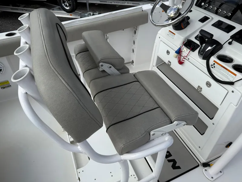 Slide: The Image of 2022 Sportsman Open 232 Center Console boat interior with cushioned seating and control panel. - 31