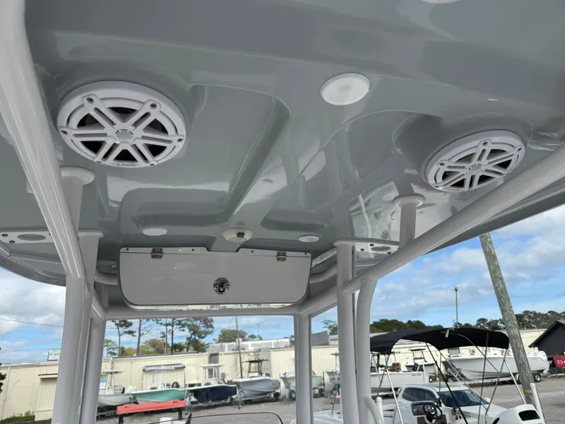Slide: The Image of 2022 Sportsman Open 232 Center Console boat with speakers on the overhead console. - 35