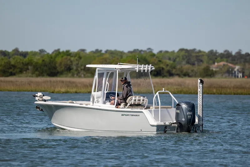 Slide: The Image of 2022 Sportsman Open 232 Center Console boat cruising on a calm lake. - 4