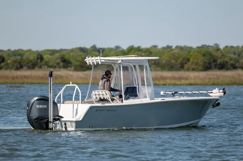 Slide: The Image of 2022 Sportsman Open 232 Center Console boat cruising on a calm lake. - 5