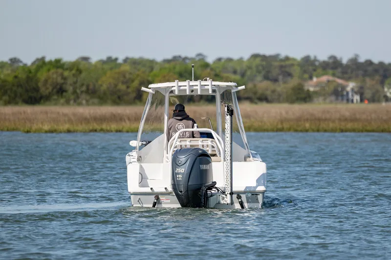 Slide: The Image of 2022 Sportsman Open 232 Center Console boat cruising on a calm lake. - 6