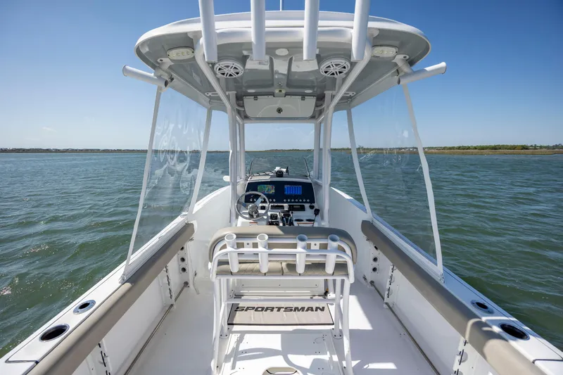 Slide: The Image of 2022 Sportsman Open 232 Center Console boat on water, showcasing helm and seating area. - 8