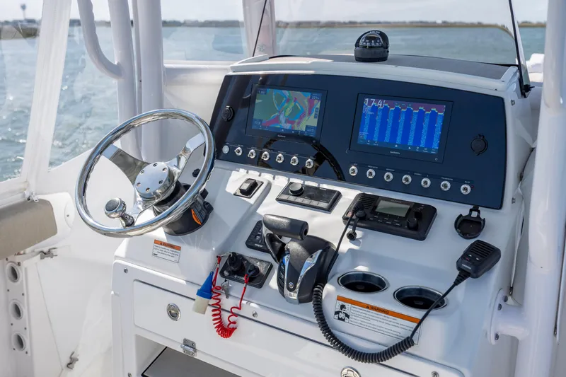 Slide: The Image of 2022 Sportsman Open 232 Center Console dashboard with navigation screens and controls. - 9