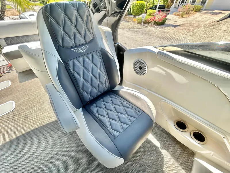 Slide: The Image of Luxurious seating in a 2021 Bennington 30 boat, featuring diamond-stitched upholstery. - 13