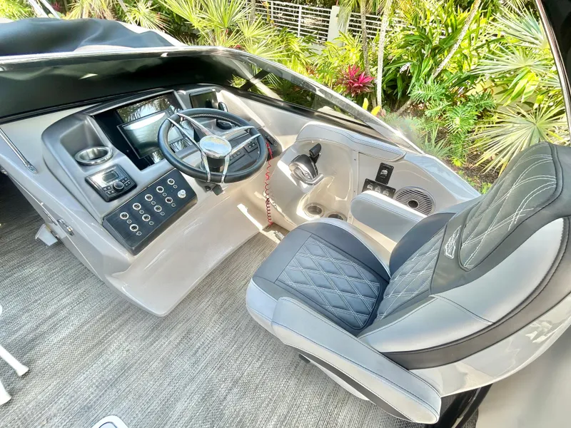 Slide: The Image of 2021 Bennington 30 boat cockpit with modern steering and luxurious seating. - 9