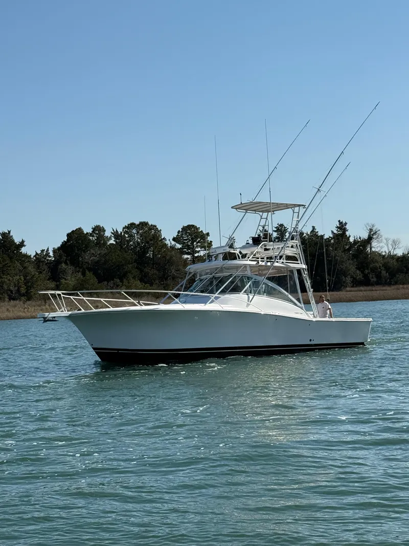 The Image of 2005 Luhrs 36 boat on calm water with clear sky background. - 1