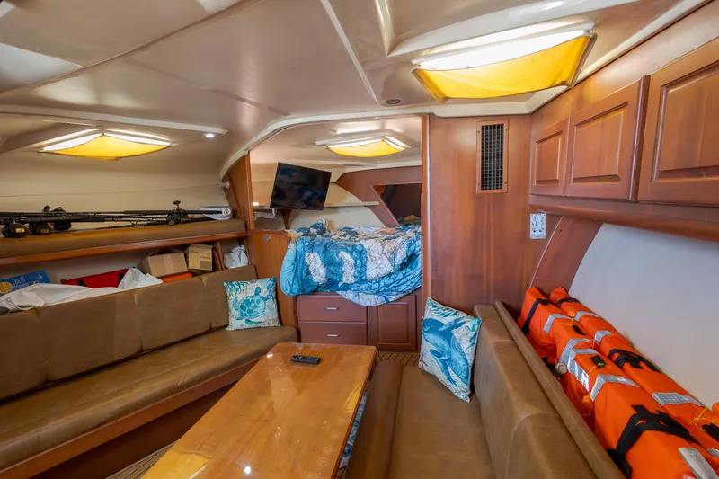 Slide: The Image of Interior of 2005 Luhrs 36 boat with cozy seating, table, and life jackets. - 11