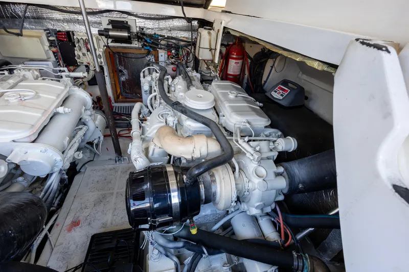 Slide: The Image of Engine room of a 2005 Luhrs 36 boat, featuring dual engines and equipment. - 13
