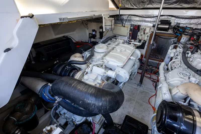 Slide: The Image of Engine room of a 2005 Luhrs 36 boat, showcasing dual engines and mechanical components. - 14